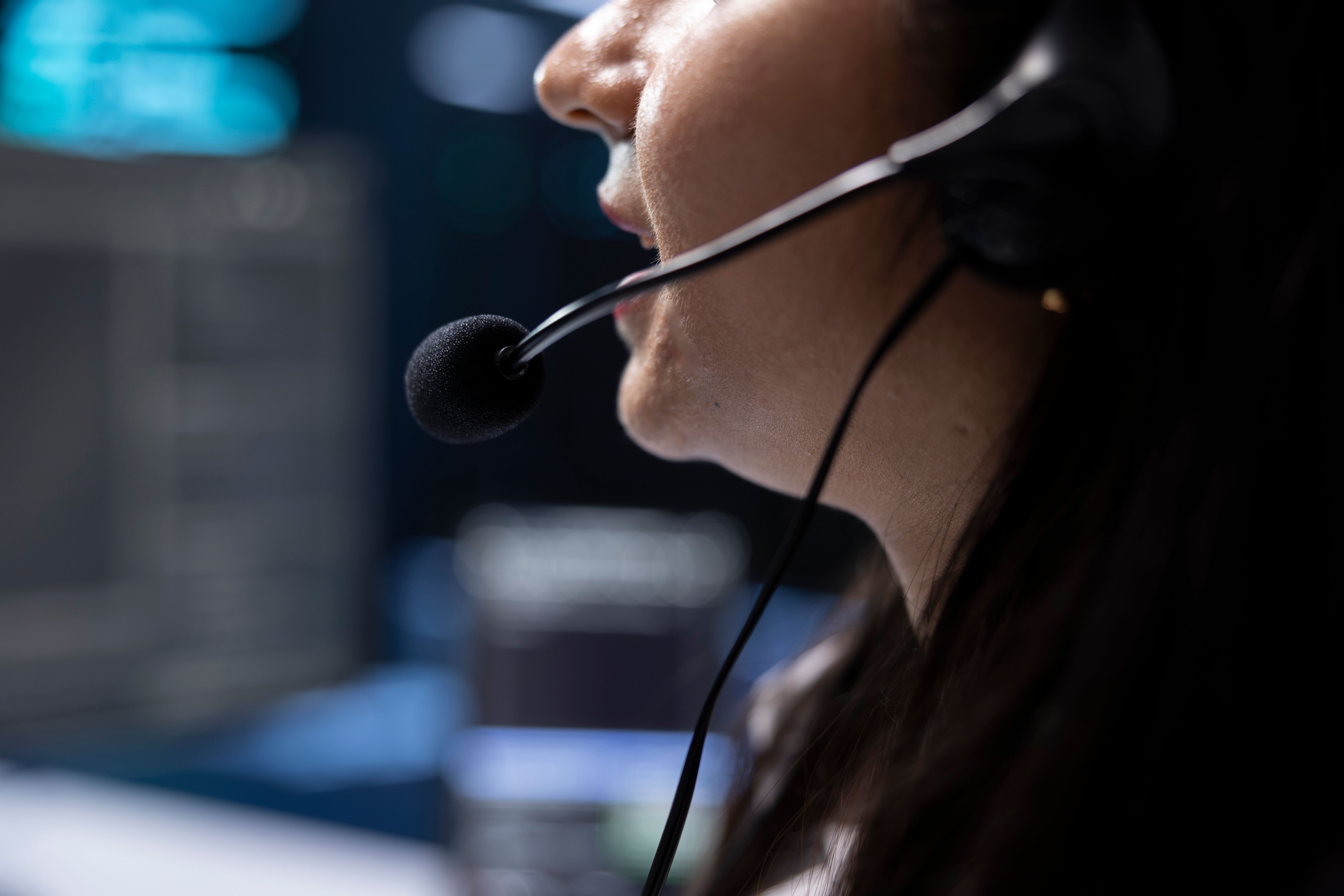 close-up-employee-server-hub-coordinating-technicians-using-mic.jpg